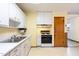 Functional kitchen featuring white cabinets and classic appliances at 1012 Roxboro St, Haw River, NC 27258