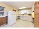Functional kitchen with ample white cabinets, a refrigerator, and essential appliances at 1012 Roxboro St, Haw River, NC 27258