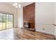 Inviting living room showcasing a brick fireplace and sliding glass doors to the backyard at 1012 Roxboro St, Haw River, NC 27258