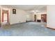 Open-concept living room with white walls, carpet, and an open view of the stairway at 1012 Roxboro St, Haw River, NC 27258