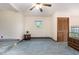 Cozy living room featuring light blue carpet, a ceiling fan, and natural light from the window at 1012 Roxboro St, Haw River, NC 27258