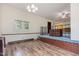Open-concept living space with decorative wood flooring and light blue carpet in the adjacent space at 1012 Roxboro St, Haw River, NC 27258