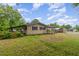 Exterior of the home featuring a cozy covered area and a large side yard at 1012 Roxboro St, Haw River, NC 27258
