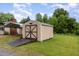 Outside storage shed with a rustic design and functional ramp, set in a well-maintained yard at 1012 Roxboro St, Haw River, NC 27258