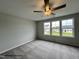 Neutral bedroom featuring plush carpet, a ceiling fan, and lots of natural light at 107 Legolas Ct, Middlesex, NC 27557