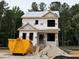 New construction of a two-story home with visible framing and materials, set against a backdrop of lush green trees at 117 Legolas Ct, Middlesex, NC 27557