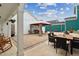 Paver patio with multiple seating areas under string lights in a backyard with white and teal siding at 1211 Gloriosa St, Apex, NC 27523