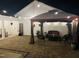 Night view of a well-lit paver patio with outdoor seating areas and ambient string lights at 1211 Gloriosa St, Apex, NC 27523
