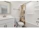 Bathroom features a shower and tub combination, white vanity, framed mirror, and tiled flooring at 1211 Gloriosa St, Apex, NC 27523