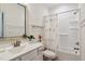 Bright bathroom featuring modern vanity, shower-tub combination, and stylish floral accents at 1211 Gloriosa St, Apex, NC 27523