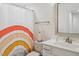 Cozy bathroom featuring a vibrant shower curtain, white fixtures, and ample lighting at 1211 Gloriosa St, Apex, NC 27523