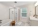 Bathroom featuring a glass-enclosed shower, soaking tub and sleek fixtures at 1211 Gloriosa St, Apex, NC 27523