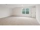 Spacious bedroom features neutral carpet, a window that provides natural light, and white trim at 1211 Gloriosa St, Apex, NC 27523