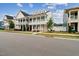 Inviting two-story home featuring double porches, a white facade, and manicured front lawn at 1211 Gloriosa St, Apex, NC 27523