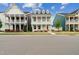 Charming two-story home featuring double porches, a white facade, and colorful doors at 1211 Gloriosa St, Apex, NC 27523