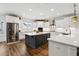 Modern kitchen with stainless steel appliances, a large island, and sleek white countertops at 1211 Gloriosa St, Apex, NC 27523