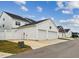 Street view of townhomes features attached garages and white picket fences at 1211 Gloriosa St, Apex, NC 27523