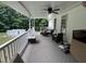 A back porch includes outdoor seating and décor creating a relaxing space overlooking a pool at 1312 High Ridge Dr, Mebane, NC 27302