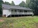 Expansive back porch with white railings and fan offers a great outdoor living space at 1312 High Ridge Dr, Mebane, NC 27302