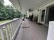 A spacious, covered back porch offers an area for outdoor relaxation and entertainment overlooking a pool at 1312 High Ridge Dr, Mebane, NC 27302