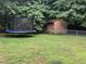 A spacious backyard features a trampoline and an outdoor shed providing ample outdoor recreation and storage at 1312 High Ridge Dr, Mebane, NC 27302