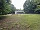 View of a large backyard surrounded by a chainlink fence and mature trees at 1312 High Ridge Dr, Mebane, NC 27302