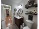 A beautifully decorated bathroom showcasing dark wood vanity, stylish fixtures, and decorative wall accents at 1312 High Ridge Dr, Mebane, NC 27302