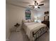 Cozy bedroom with a wrought iron bed frame, neutral bedding, and a unique arched window with blind at 1312 High Ridge Dr, Mebane, NC 27302