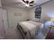Bright bedroom with a wrought iron bed frame, neutral bedding, and a unique arched window at 1312 High Ridge Dr, Mebane, NC 27302