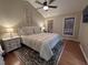 A spacious bedroom with wood floors, a ceiling fan, and a comfortable bed with an upholstered headboard at 1312 High Ridge Dr, Mebane, NC 27302