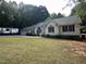Charming single-Gathering home with lush lawn, garden beds, and a three-car garage at 1312 High Ridge Dr, Mebane, NC 27302