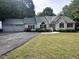 Single story home with attached three-car garage and well-maintained landscaping at 1312 High Ridge Dr, Mebane, NC 27302