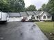 Traditional-style home with an attached three-car garage and a paved driveway at 1312 High Ridge Dr, Mebane, NC 27302