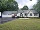 A single-Gathering home with a three-car garage, landscaping and a paved driveway at 1312 High Ridge Dr, Mebane, NC 27302