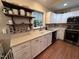 Updated kitchen with white cabinets, stainless steel appliances, and a double sink at 1312 High Ridge Dr, Mebane, NC 27302