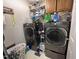 Efficient laundry room featuring modern, front-load washer and dryer units with ample storage space at 1312 High Ridge Dr, Mebane, NC 27302