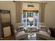 Well-appointed living room with a window view, cozy seating, and hardwood floors at 1312 High Ridge Dr, Mebane, NC 27302