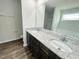 Bathroom featuring double sinks, granite countertops, a separate toilet room, and a shower at 138 Sourgum Ct, Zebulon, NC 27597