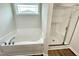 Bathroom showcasing a soaking tub, glass shower, and natural light at 138 Sourgum Ct, Zebulon, NC 27597