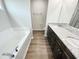 Elegant bathroom featuring double sinks, granite countertops, a soaking tub, and a separate shower at 138 Sourgum Ct, Zebulon, NC 27597