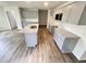 Modern kitchen featuring gray cabinets, stainless appliances, and a granite island at 138 Sourgum Ct, Zebulon, NC 27597