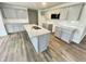 Modern kitchen featuring gray cabinets, stainless appliances, and a granite island at 138 Sourgum Ct, Zebulon, NC 27597