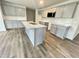Modern kitchen featuring gray cabinets, stainless appliances, and a granite island at 138 Sourgum Ct, Zebulon, NC 27597