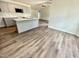 Open concept kitchen with gray cabinets, granite countertops, and modern stainless steel appliances at 138 Sourgum Ct, Zebulon, NC 27597