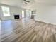 Bright living room featuring wood-look floors, a fireplace, and ample natural light at 138 Sourgum Ct, Zebulon, NC 27597