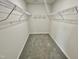 Walk-in closet with carpet flooring and metal shelving units at 138 Sourgum Ct, Zebulon, NC 27597