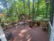 Expansive back deck with seating, offering a perfect outdoor entertainment area surrounded by lush greenery and mature trees at 14 Striding Ridge Ct, Durham, NC 27713