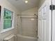 Clean bathroom featuring a tub-shower combination, white tile, and a window that brings in natural light at 14 Striding Ridge Ct, Durham, NC 27713