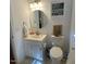 Clean bathroom with modern lighting, white vanity, and a round mirror at 14 Striding Ridge Ct, Durham, NC 27713