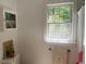 Cozy bathroom featuring a window, storage cabinet, and towel rack for a pleasant experience at 14 Striding Ridge Ct, Durham, NC 27713